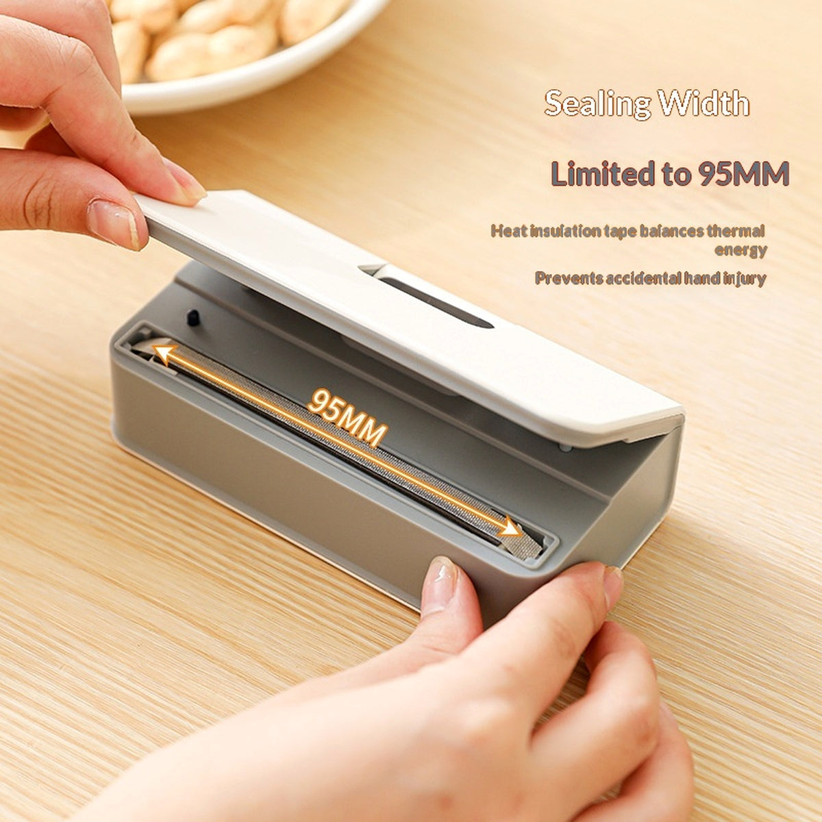 Opening the mini bag sealer to show the 95 mm sealing strip