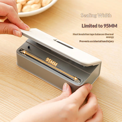 Opening the mini bag sealer to show the 95 mm sealing strip